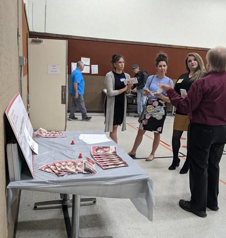 3 Guests standing listening to Mike present Festival of Trees