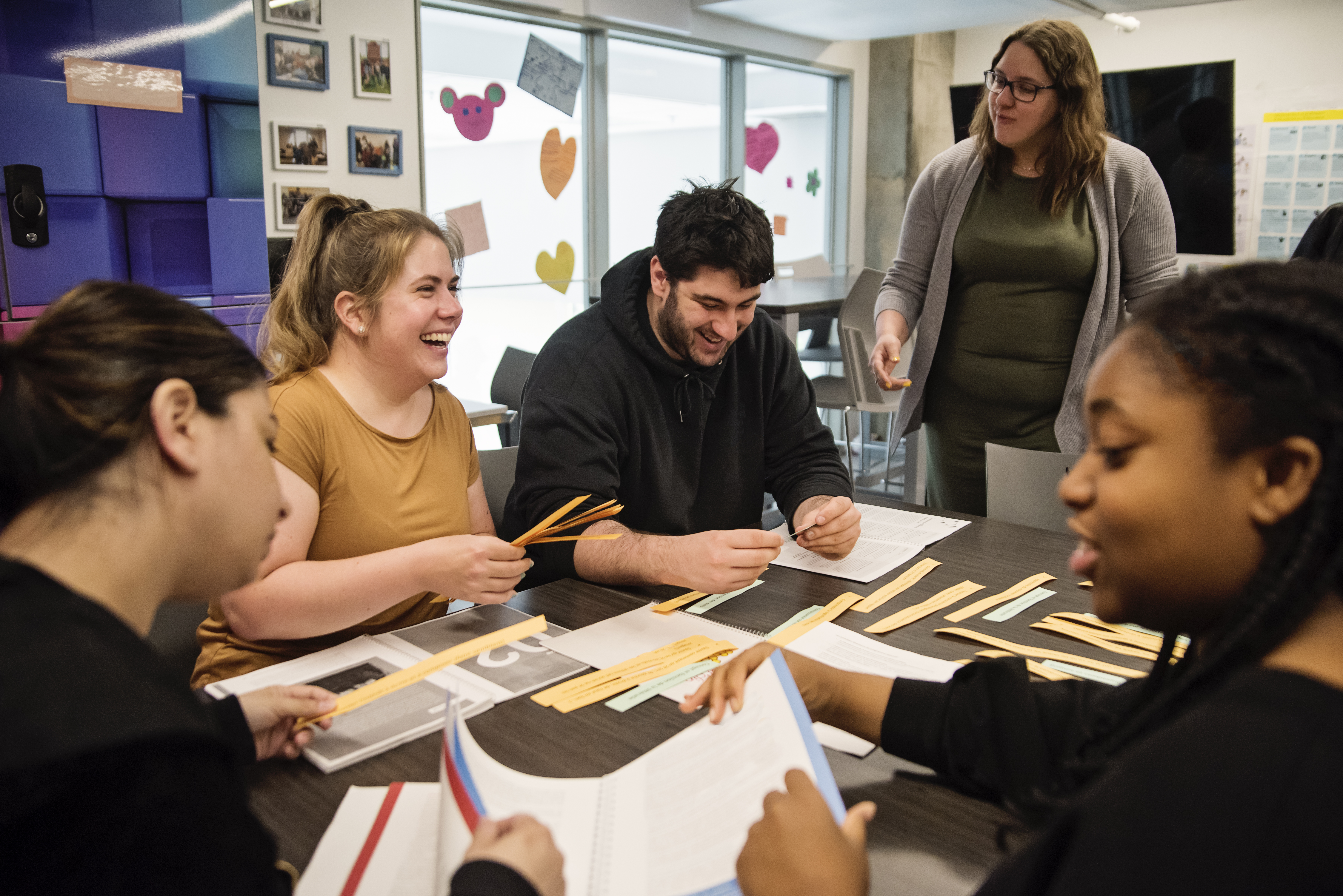 Group of 4 adults around table working on an art project